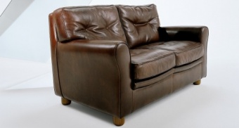 Oxford sofa. 165x94 h.89 Beltford Cognac with profile Hunter Seppia - available also in the size 195x94 h.89 and 225x94 h.89; armchair 94x94 h.89 and pouf 65x65 h.43